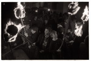 Boys carrying flaming torches at the start of the Carnival parade by James Ravilious
