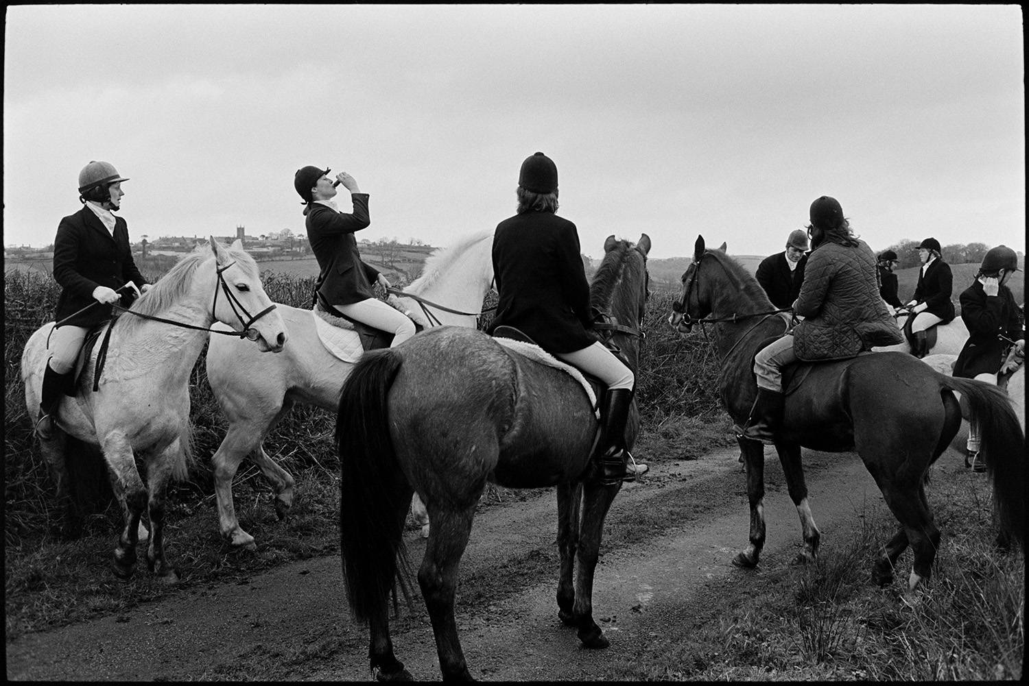 Hunt Meet, horses and followers setting off. 
[Horse riders about to set off along a lane in Highampton after their hunt meet.]