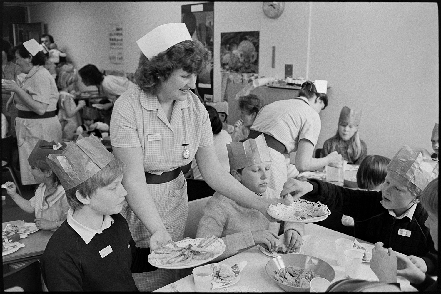 Party in children's ward of hospital, food and drink, nurses serving. 
[A nurse serving sandwiches and cakes to children at a party on the Children's Ward at Barnstaple General Hospital.]