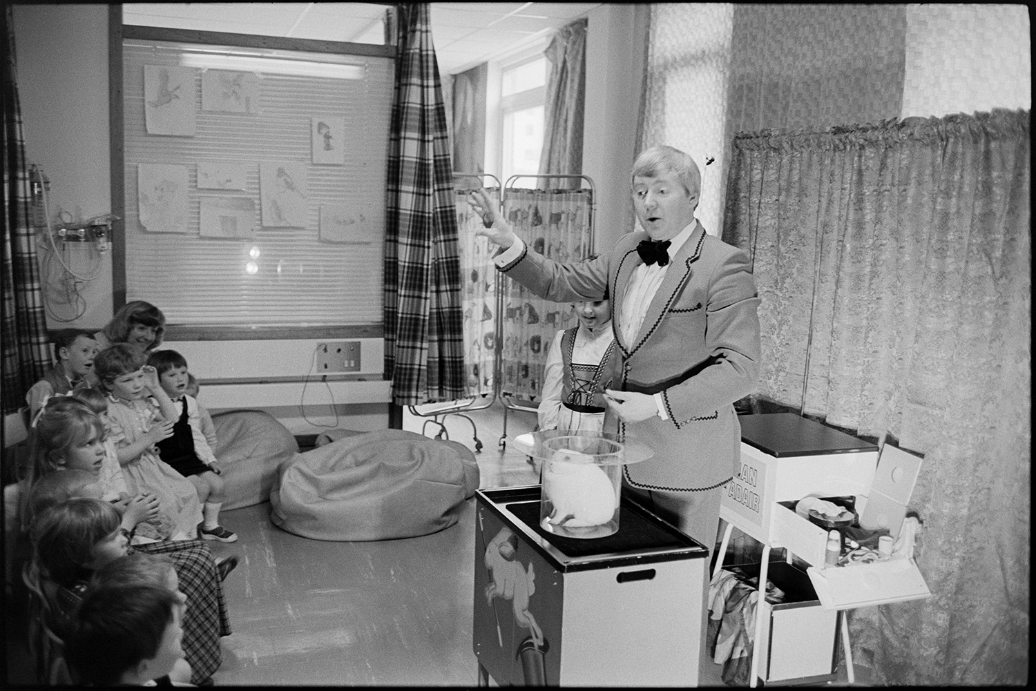Conjuror at children's party in hospital. 
[Ian Adair, a magician, entertaining children at a party on the Children's Ward at Barnstaple General Hospital. He has a rabbit in a hat.]