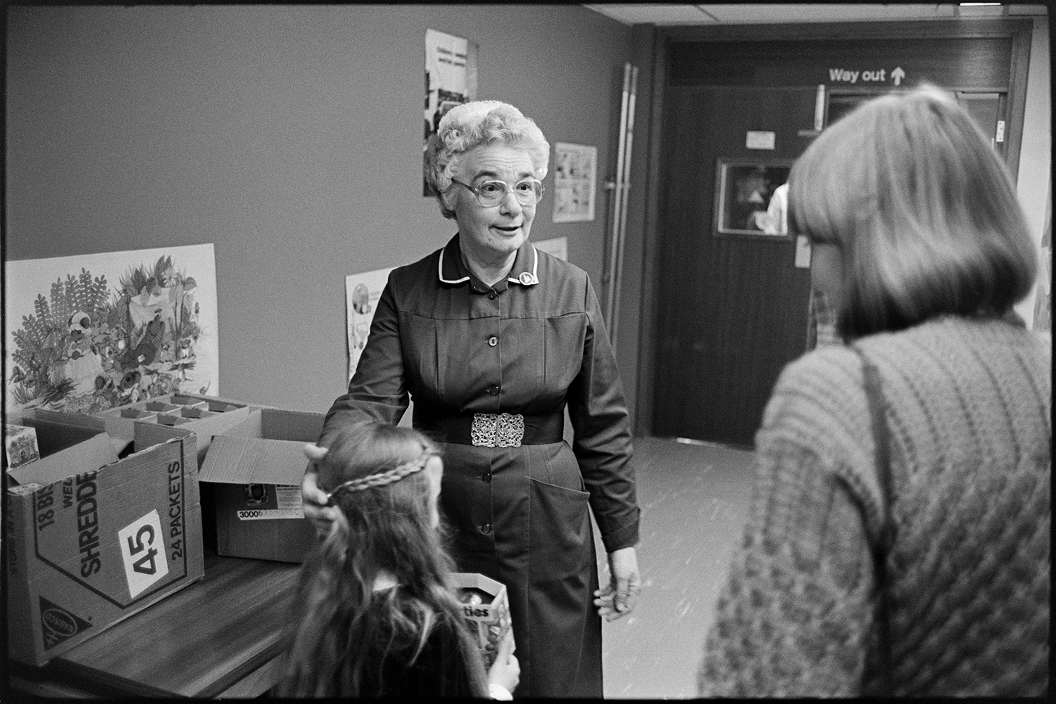 Ward Sister and nurses in ward of hospital. 
[The Ward Sister or Matron of the Children's Ward at Barnstaple general Hospital handing out an Easter egg to a girl and a woman.]