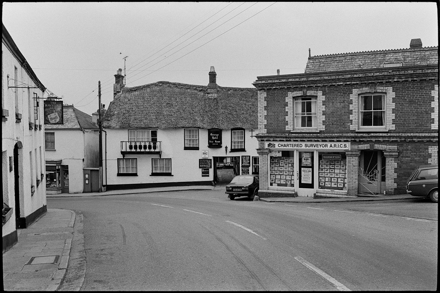 Street scene with pub.
[A view of Market Street, Hatherleigh with the Havelock Arms, The George Hotel and P. Pyle Chartered Surveyors.]
