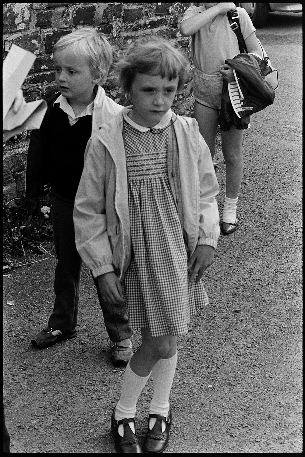 Children after school in village street. Clothes.
[Children standing in a street in Dolton after school.]