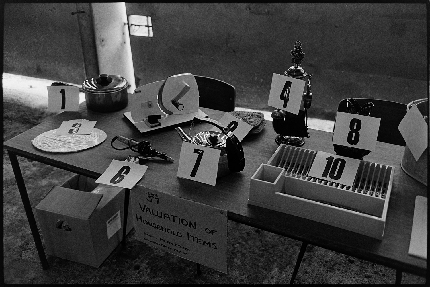 Produce at show, cakes and competitions.
[A 'Valuation of household items' stall at Hatherleigh Show.]