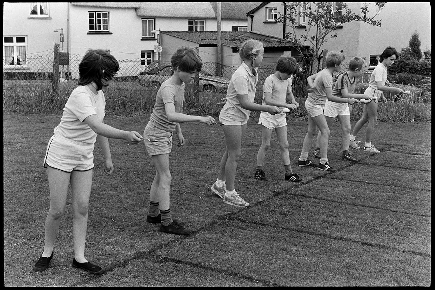 School Sports day, races, sack race, egg and spoon. 
[Children at the start line ready to compete in an egg and spoon race at Dolton School sports day.]