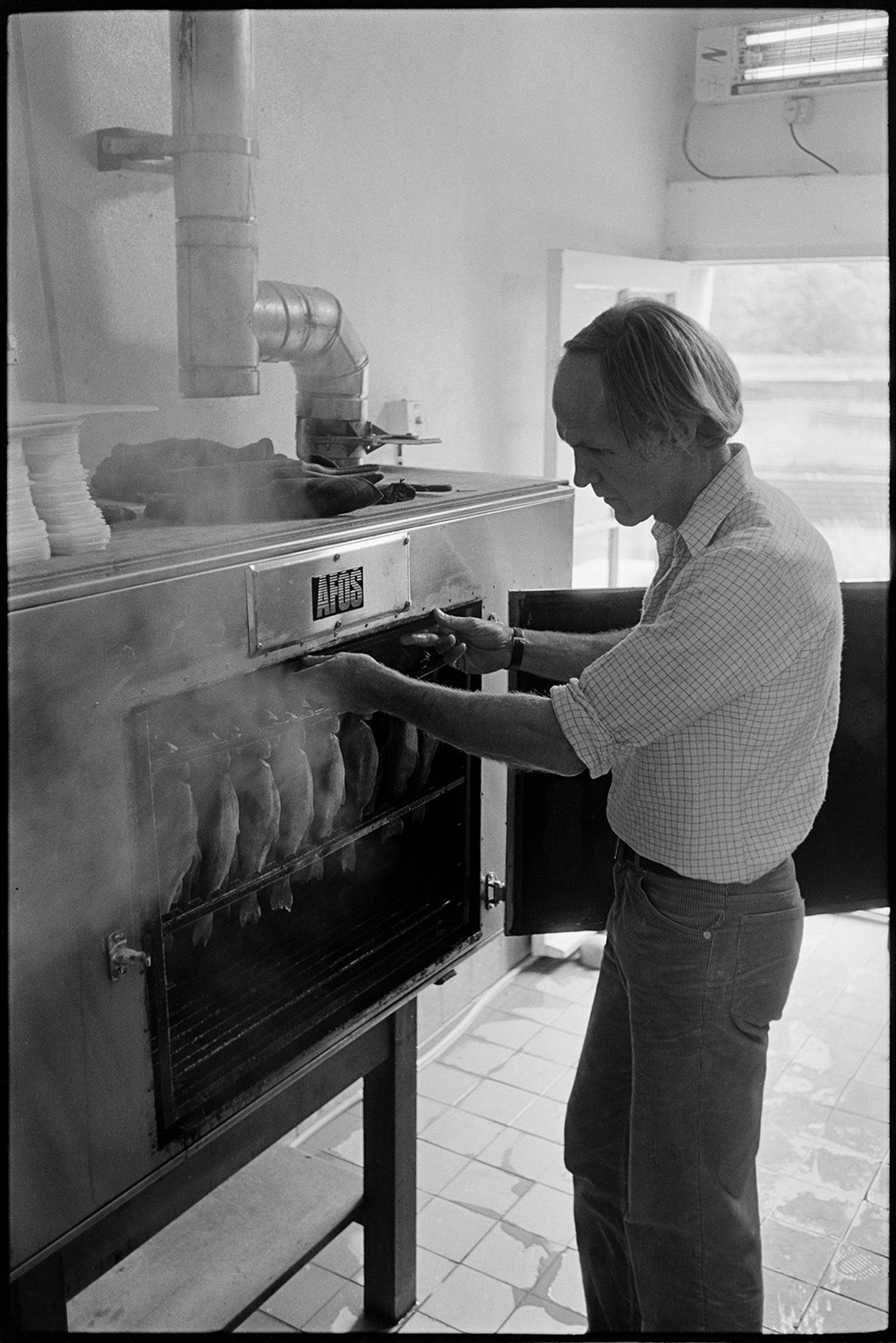 Smoking fish. 
[Robin Boa smoking fish in a large oven at Head Mill, Kings Nympton.]