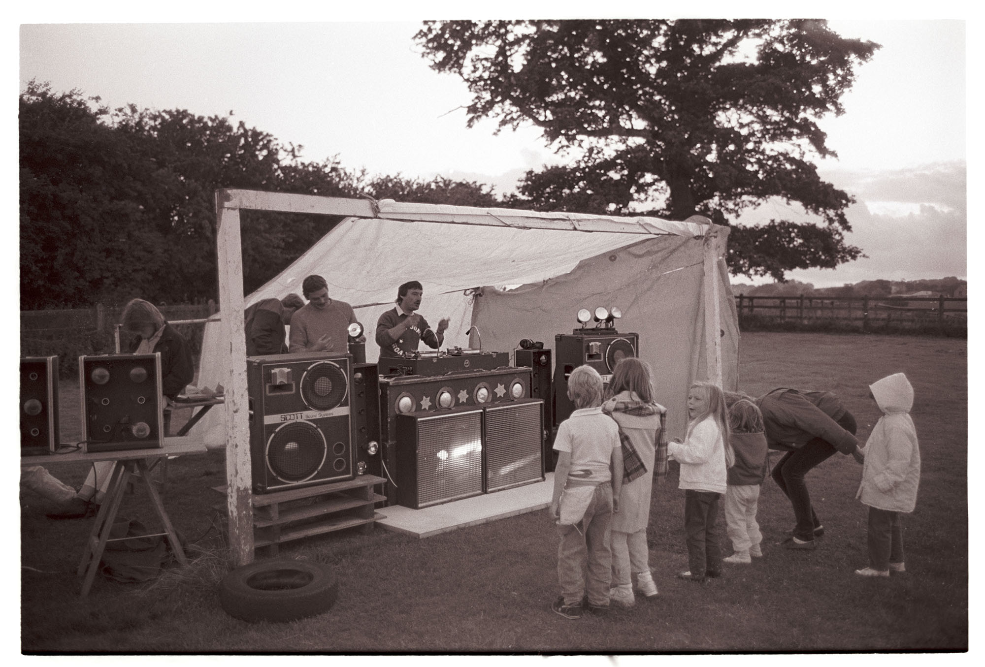 Mobile disco on the sports field by James Ravilious