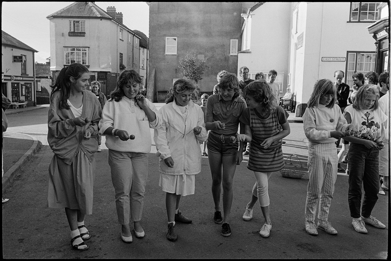 Skipping and egg and spoon race at fair.
[Girls lining up for an egg and spoon race in Fore Street, Chulmleigh.]