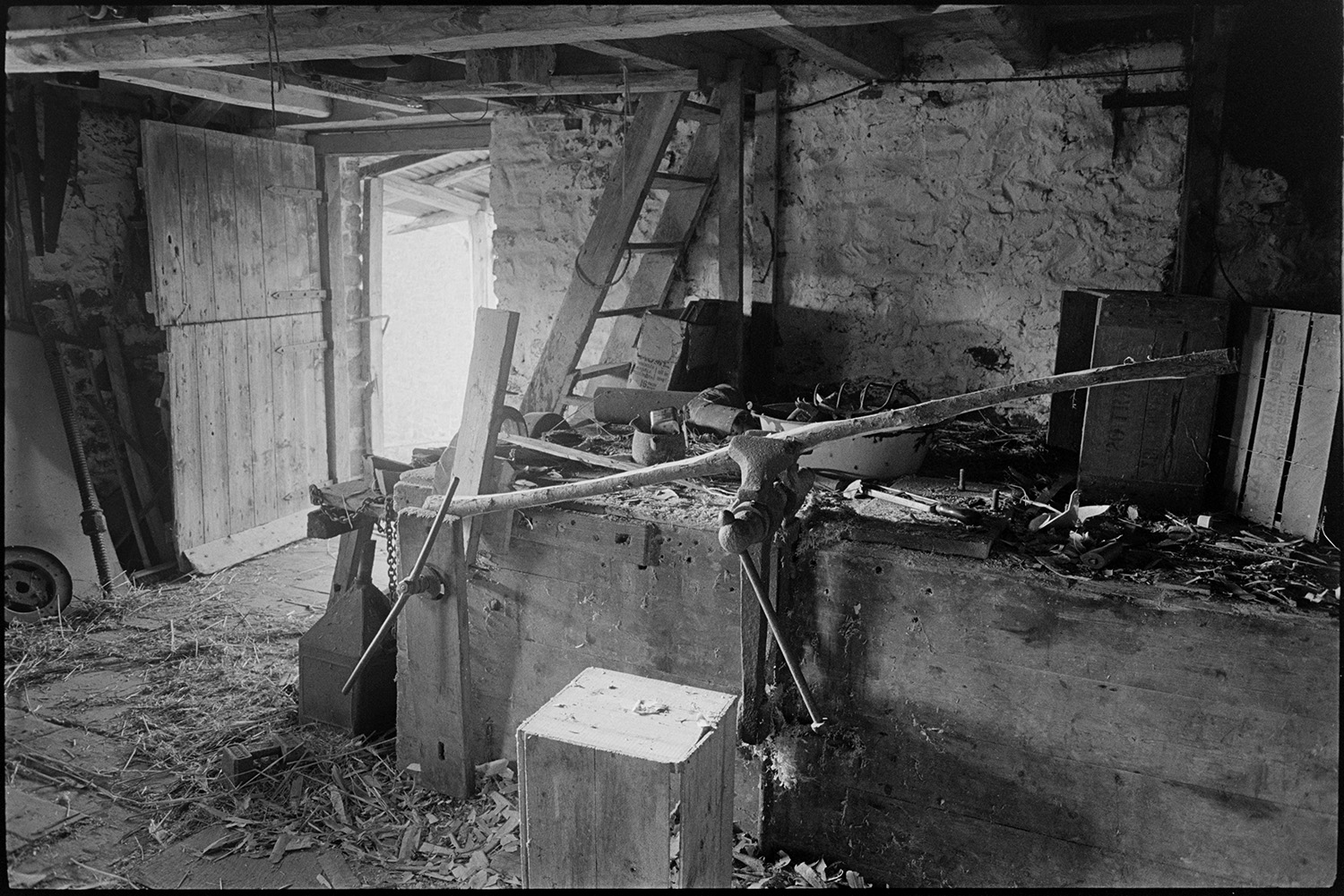 Views inside and outside of mill showing wheel and machinery and workshop. Stored nitches thatch.<br />
[Interior view of Rashleigh Mill, Bridge Reeve, showing work bench, tools, a vice, machinery, ladder, wood shavings, wooden entrance door.]