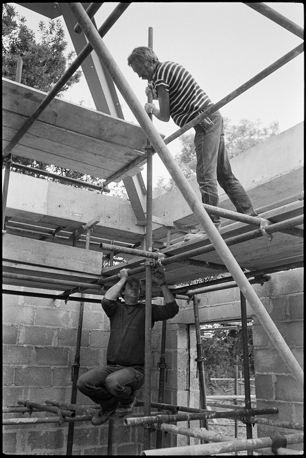 Builders at work on new school.
[Two builders erecting scaffolding during the building of the new Chulmleigh Primary School.]