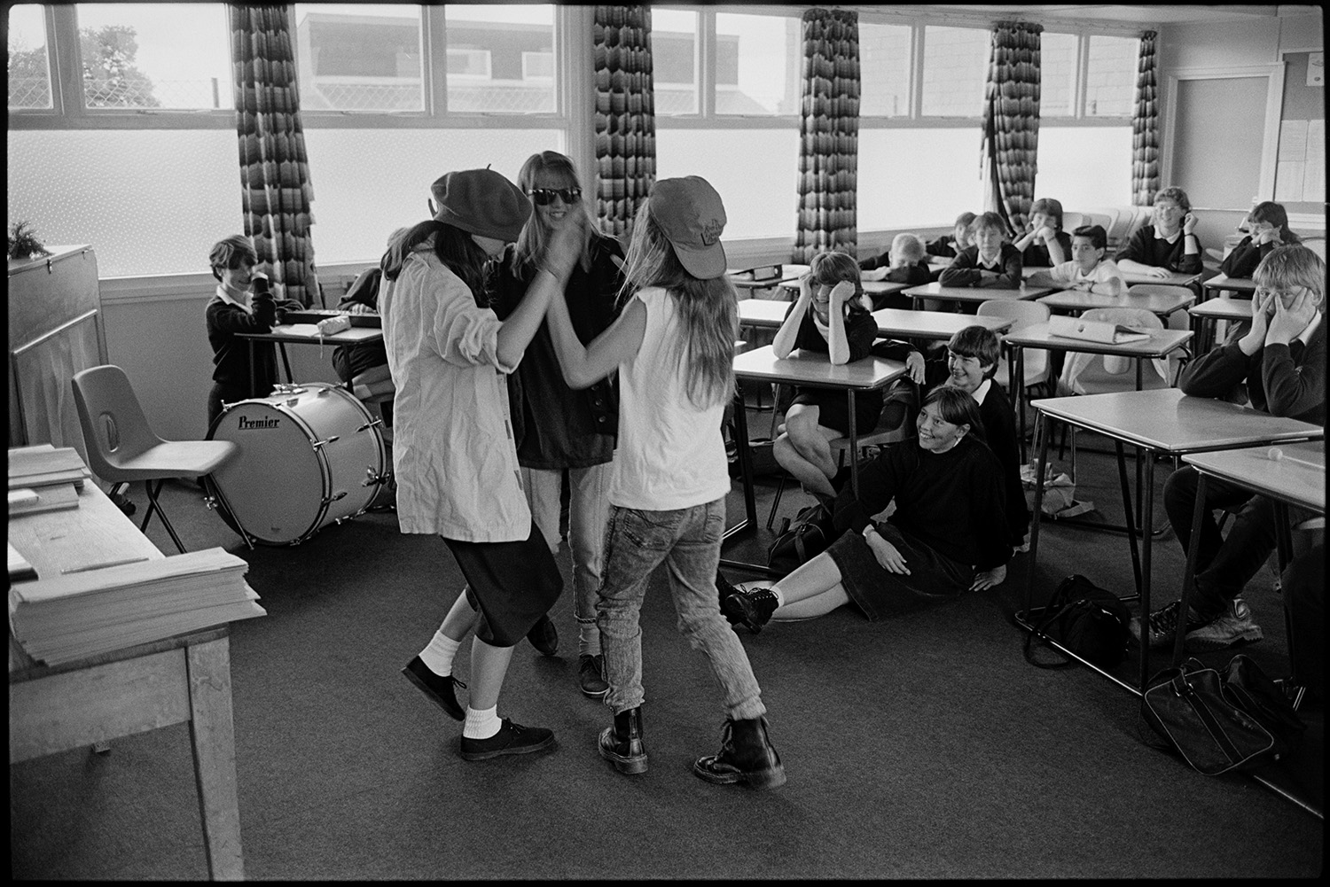 Classroom with pupils acting out short play. 
[Three pupils acting out a short play in a classroom at Chulmleigh Community College. The other students are watching them. A bass drum is also visible in the classroom.]