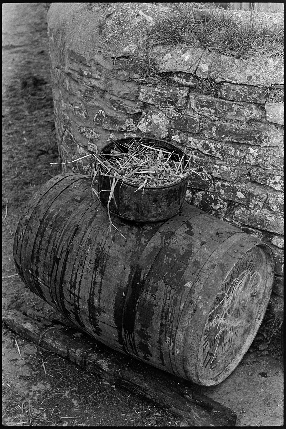Pressing cider on farm, crusher and barrel. 
[A cider barrel with a straw filter on top, in the farmyard at Spittle, Chulmleigh.]