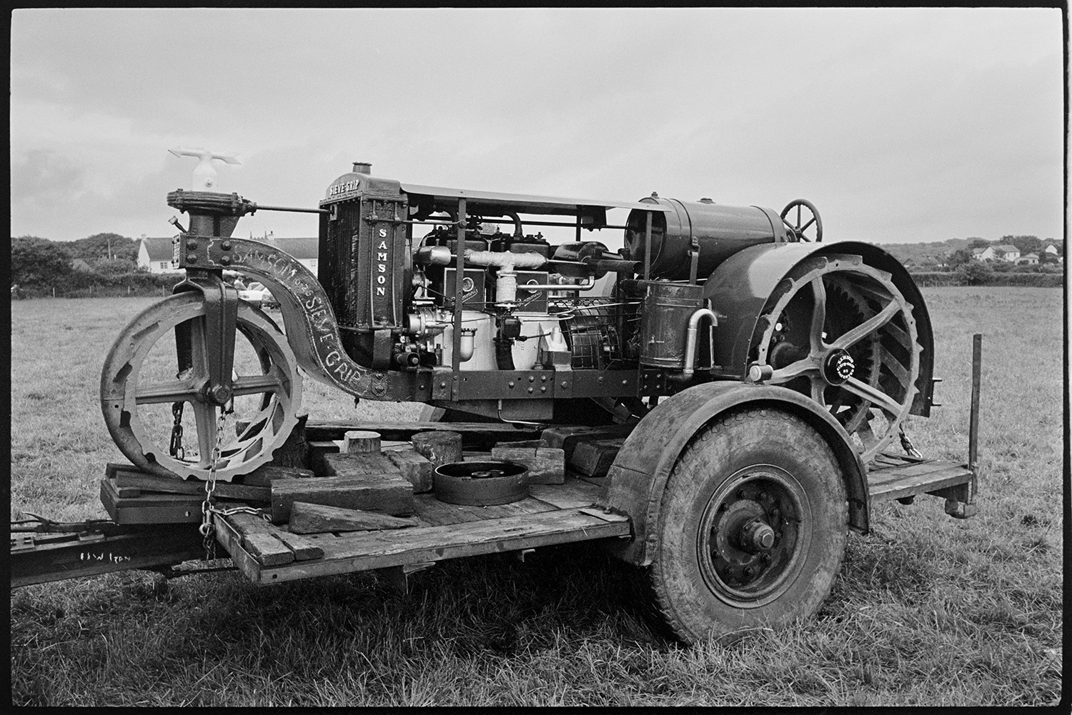 Village Club Day, sports, teas, clay pigeon shoot, committee in discussion.
[A Samsom Sieve Grip vintage tractor on a trailer in a field at the Village Club Day in Chawleigh.]
