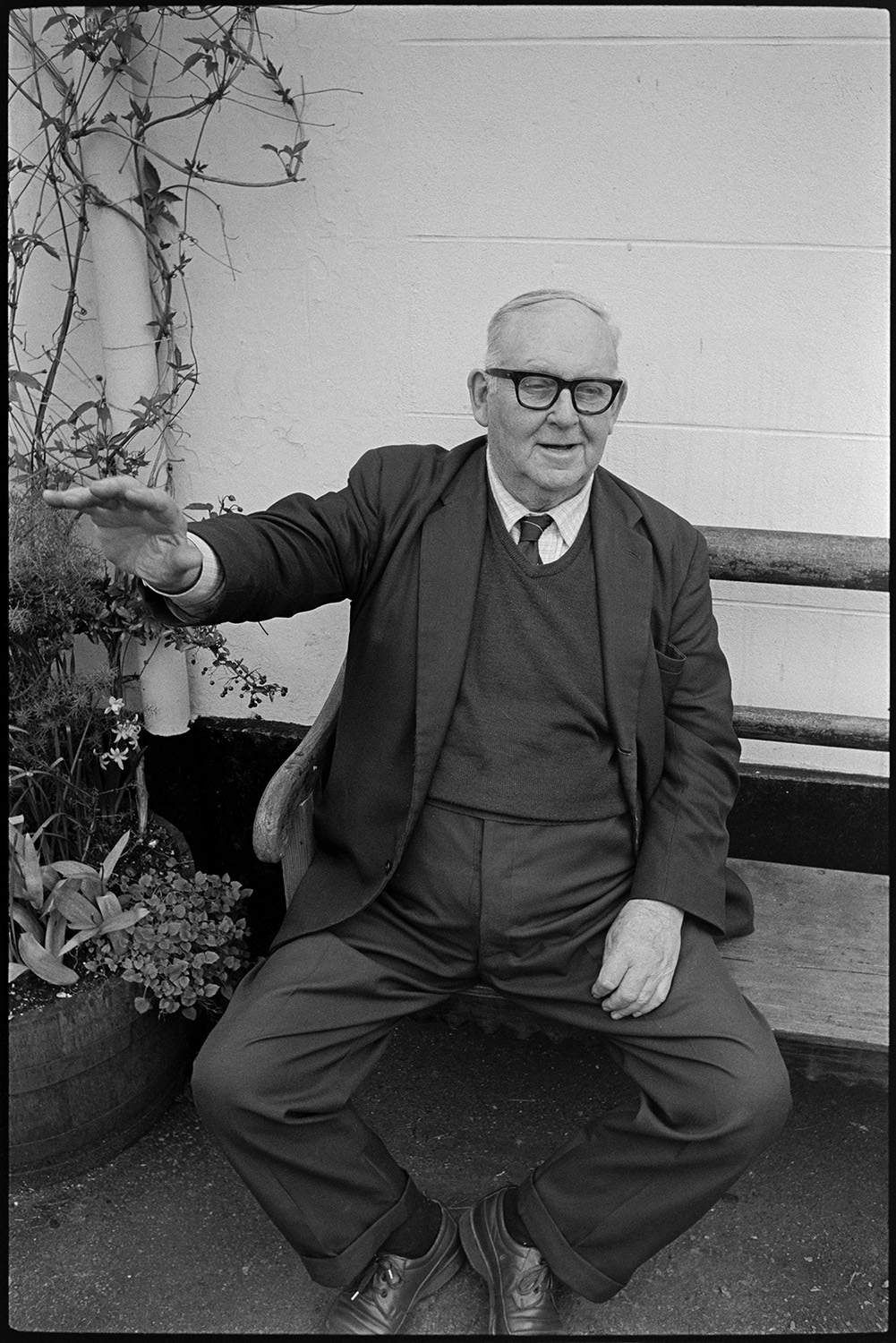 Man seated outside pub.
[Archie Bussell sitting on a bench outside a pub in Chulmleigh.]