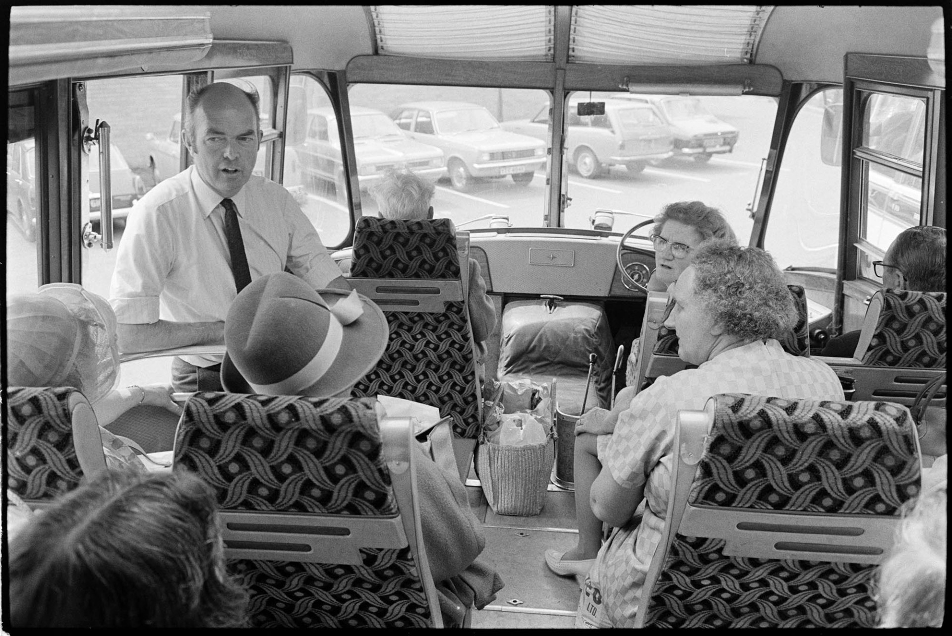 Passengers on Friday bus to Barnstaple. Driver John Beer from Chulmleigh.<br />
[Women sat at the front on the bus and talking to the driver. The woman on the extreme left wearing a hat is Mrs Turner, the proprietor of the bus company.]