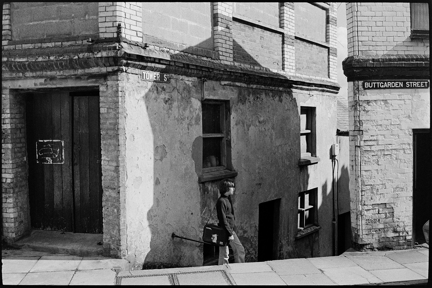 Street corner. 
[A man walking past a street corner where Buttgarden Street and Tower Street meet in Bideford.]