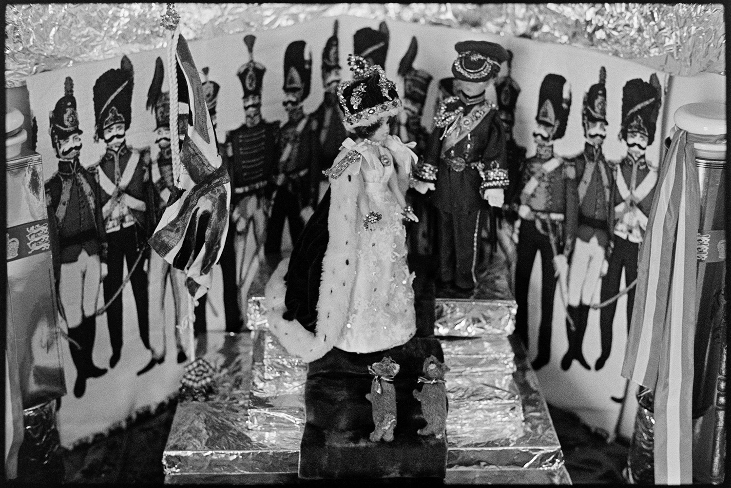 Royal display of dolls in village Post Office, Jubilee. 
[A display of royal dolls and corgis in Kings Nympton Post Office for Queen Elizabeth II Silver Jubilee.]