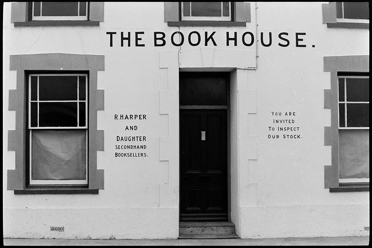 Front of second hand book shop. 
[The front door of 'The Book House', a second hand bookshop at Westward Ho! A sign next to the door reads 'R Harper and Daughter Secondhand Booksellers.'.]