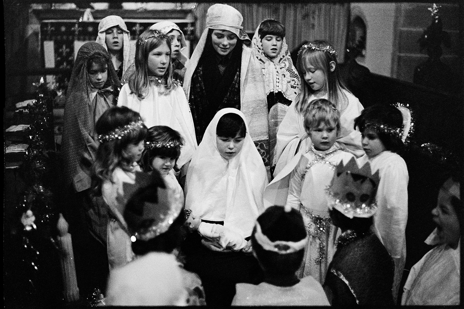 Children at Christmas Nativity play in Church. 
[A group of children performing in a nativity play in Dolton Church. They are dressed as angels, kings and shepherds.]