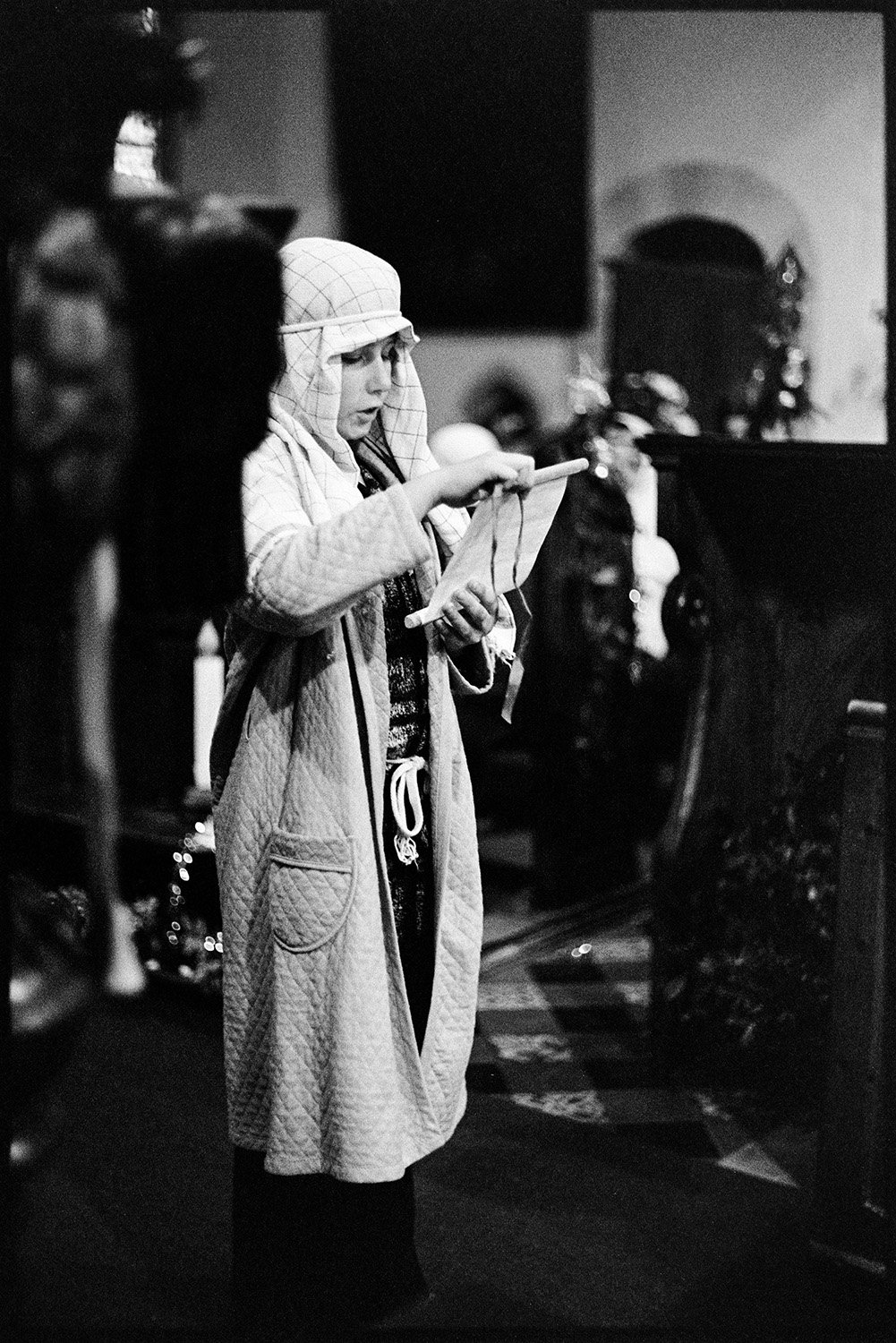 Nativity play, children in church. 
[A child giving a reading as part of a nativity play in Dolton Church. The child is dressed as a shepherd.]