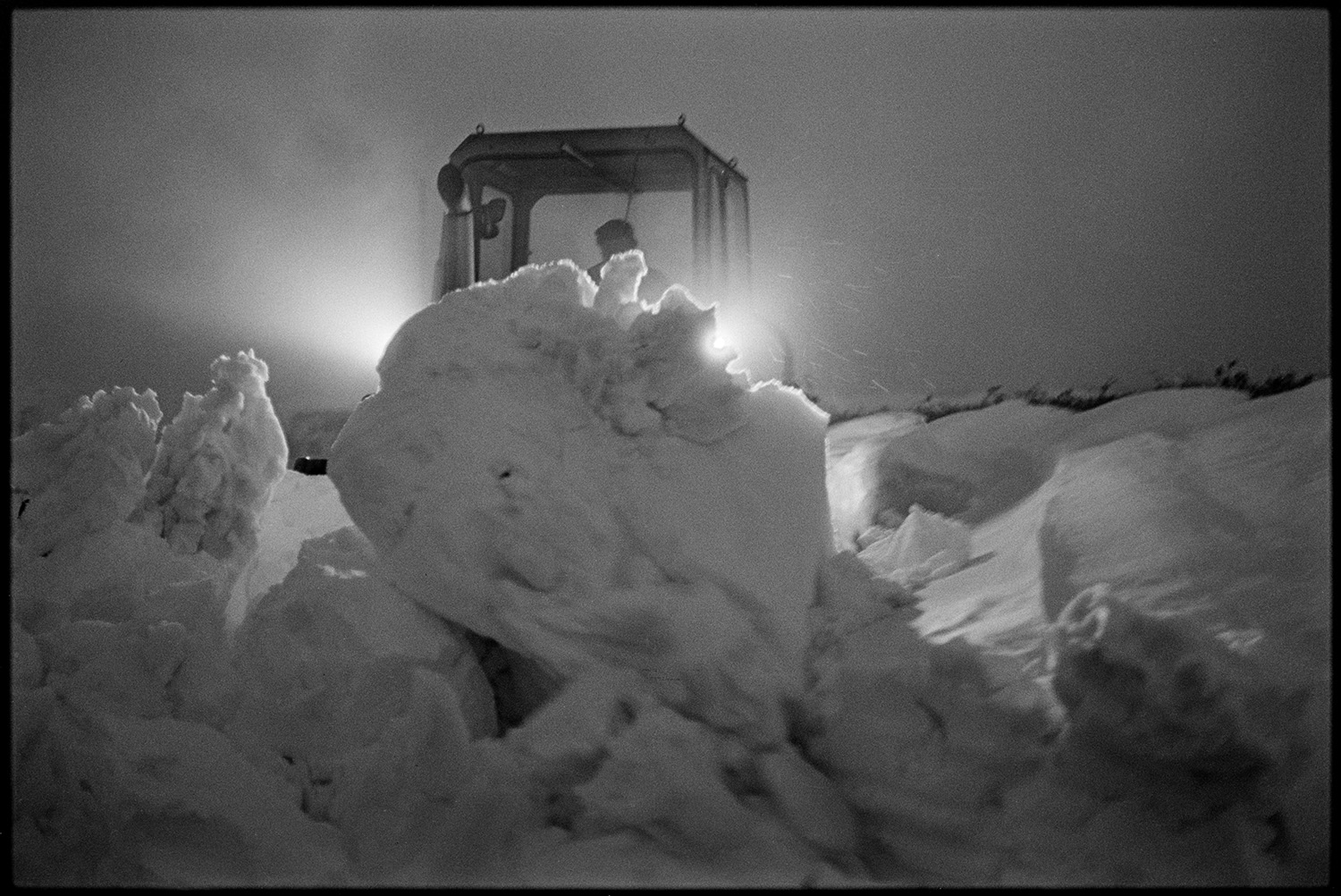 Snow, men and bulldozer clearing snowdrifts. 
[A bulldozer clearing snowdrifts at Dolton Beacon.]