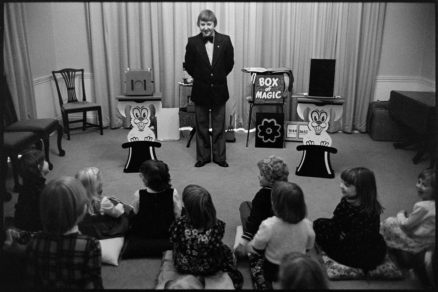 Conjurer entertaining children at birthday party. 
[A magician entertaining children at the 6th birthday of Hilary and Roger Hill's child, at Marwood House.]
