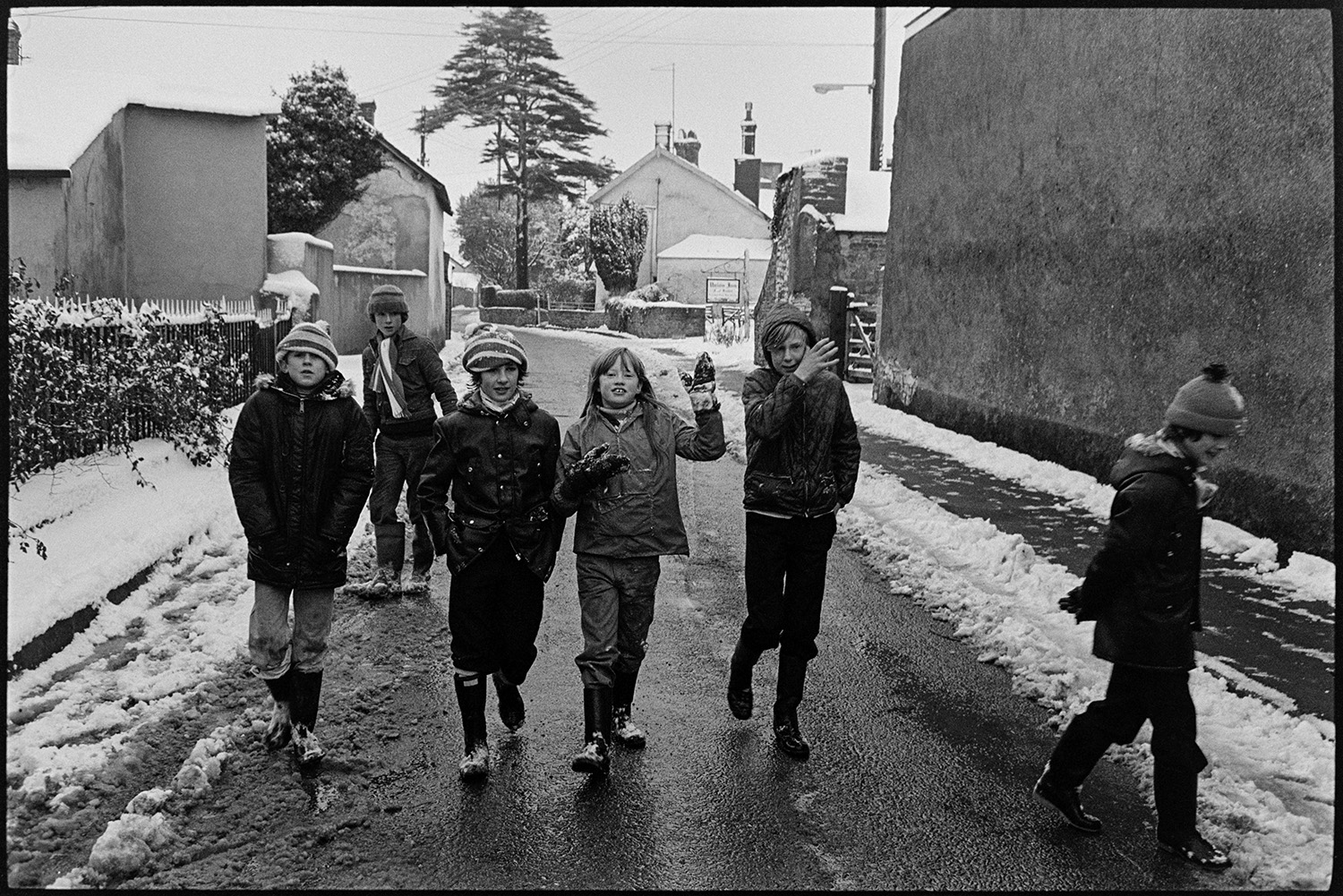 Snow, Street scenes postman and dog, children throwing snowballs, people chatting. 
[Six children walking along a snowy street in Dolton.]